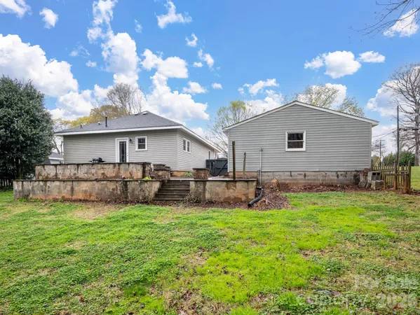 a view of a house with a yard and sitting area