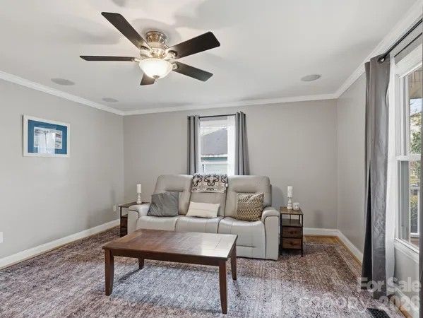 a living room with furniture a rug and a window