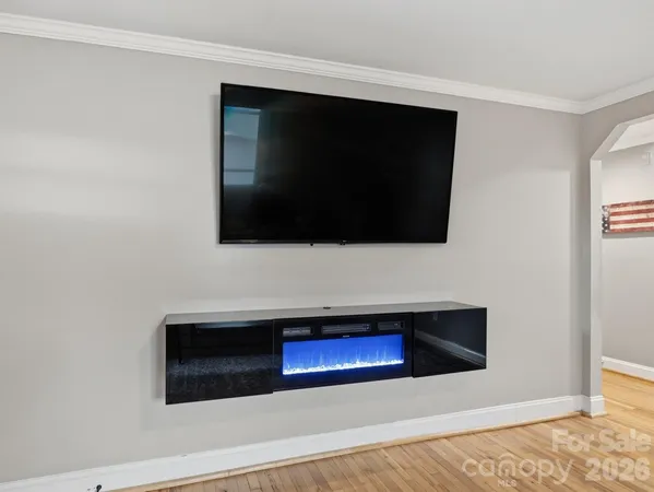 a living room with a flat screen tv and a fireplace