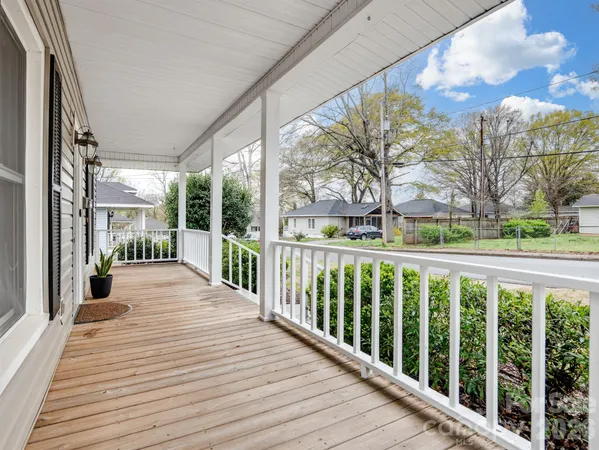 a balcony with wooden floor and outdoor space