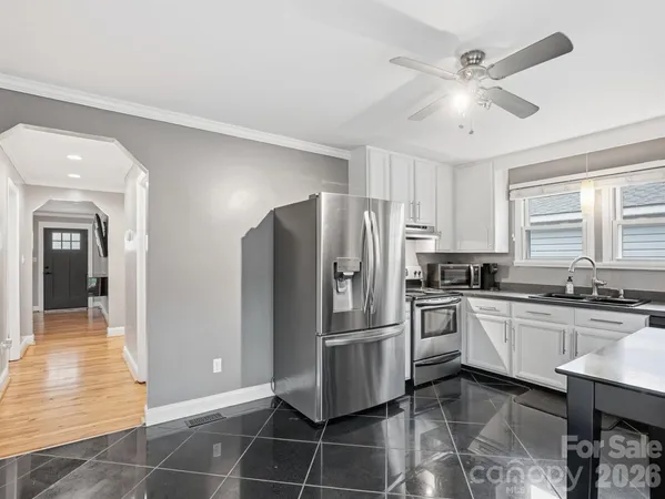 a kitchen with stainless steel appliances a refrigerator sink and microwave