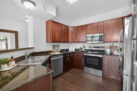 a kitchen with a sink stove and refrigerator