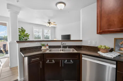 a kitchen with granite countertop a sink and cabinets