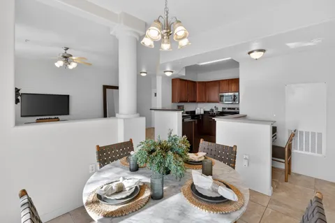 a living room with furniture a flat screen tv and kitchen view