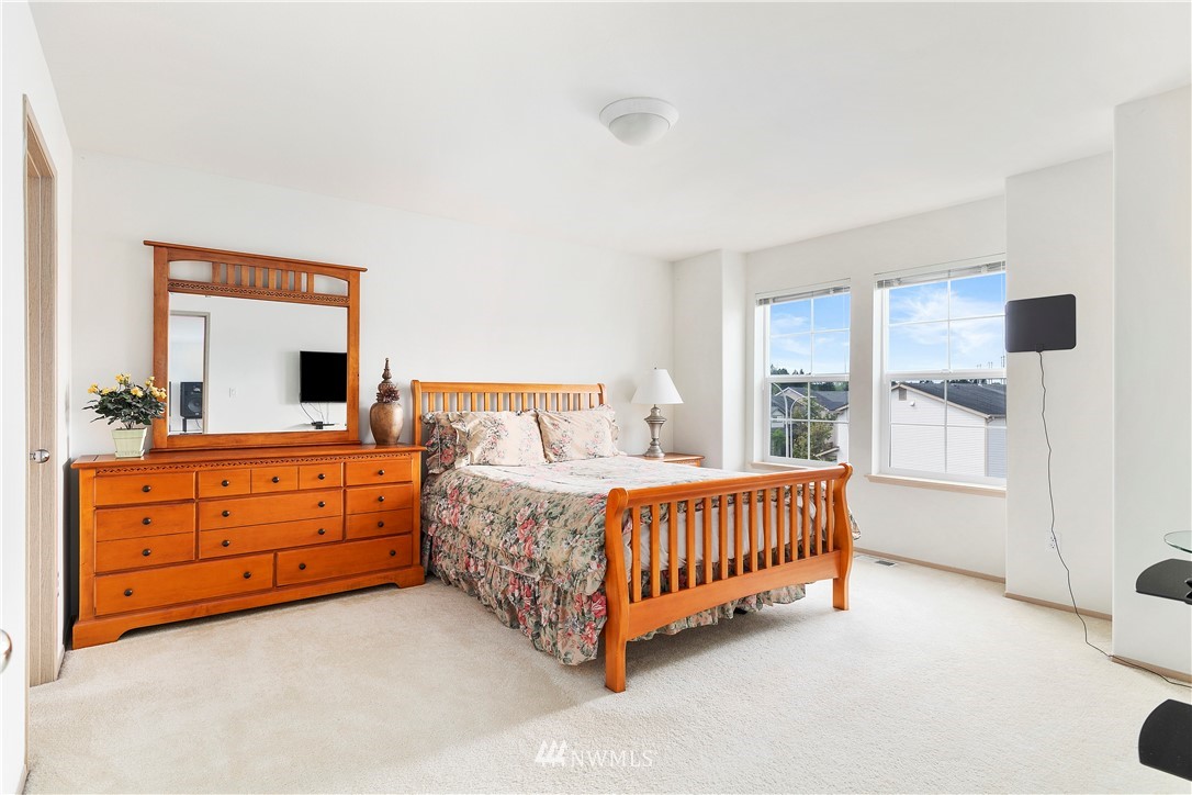 2913 Southeast 4th Street Renton, WA 98056 - Photo 22 of 36 a room with a bed and a night stand in it