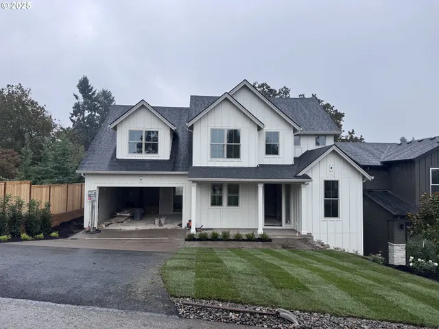 a front view of a house with a garden and yard