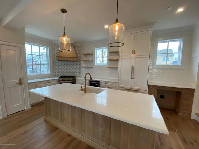 a spacious bathroom with a sink a large mirror and vanity