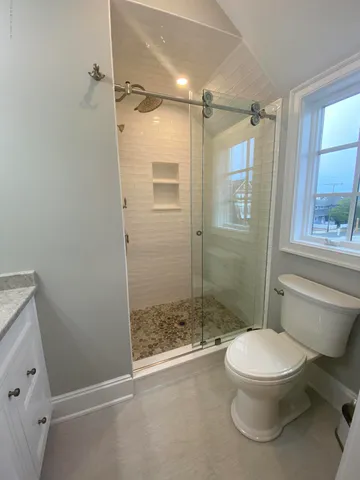 a bathroom with a toilet and a shower
