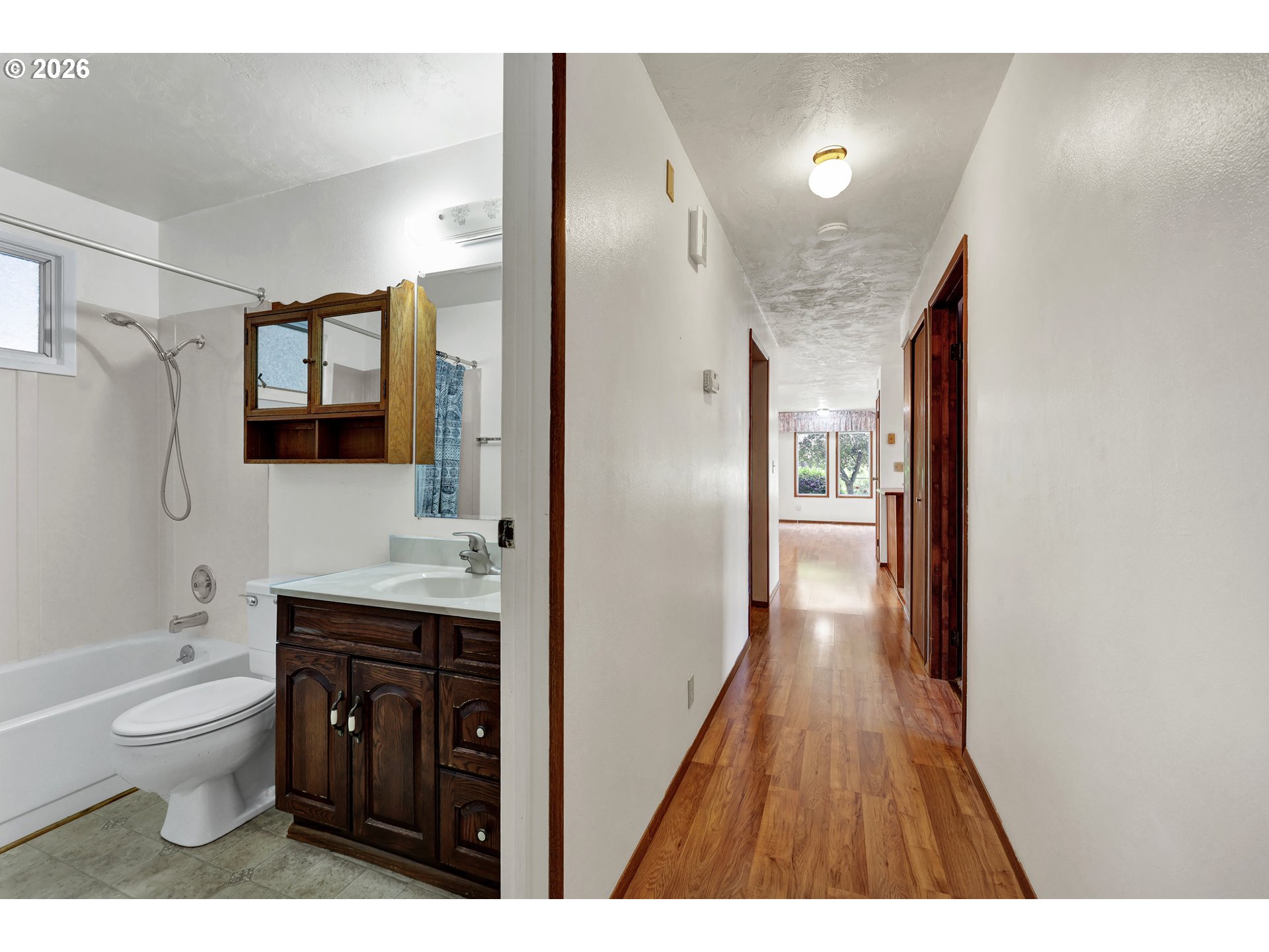1425 Taney Street Eugene, OR 97402 - Photo 20 of 34 a bathroom with a sink a toilet a shower and a mirror