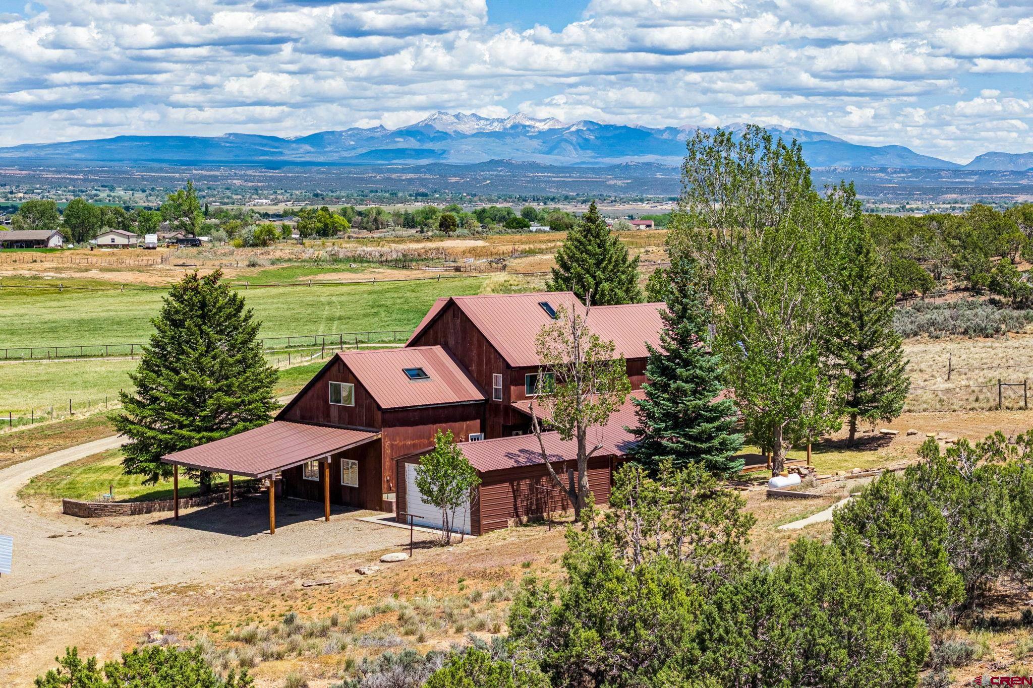 22480 Rd L Cortez, CO 81321 - Photo 37 of 44 aerial view of a house with yard and lake view