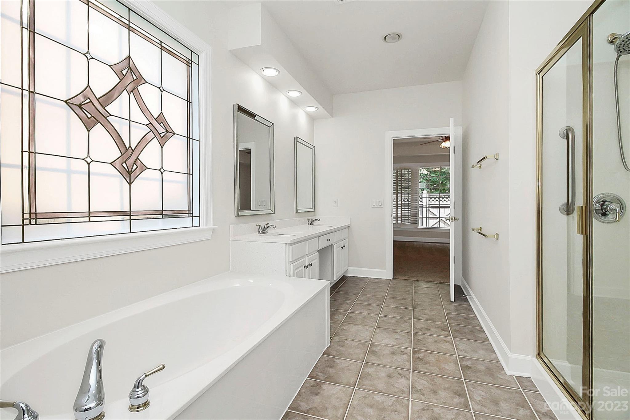 218 Robinlynn Road Matthews, NC 28105 - Photo 11 of 24 a bathroom with a tub sink and mirror