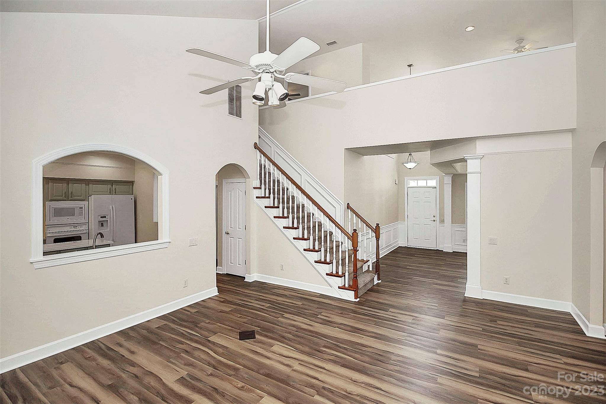 218 Robinlynn Road Matthews, NC 28105 - Photo 13 of 24 an empty room with wooden floor fan and windows