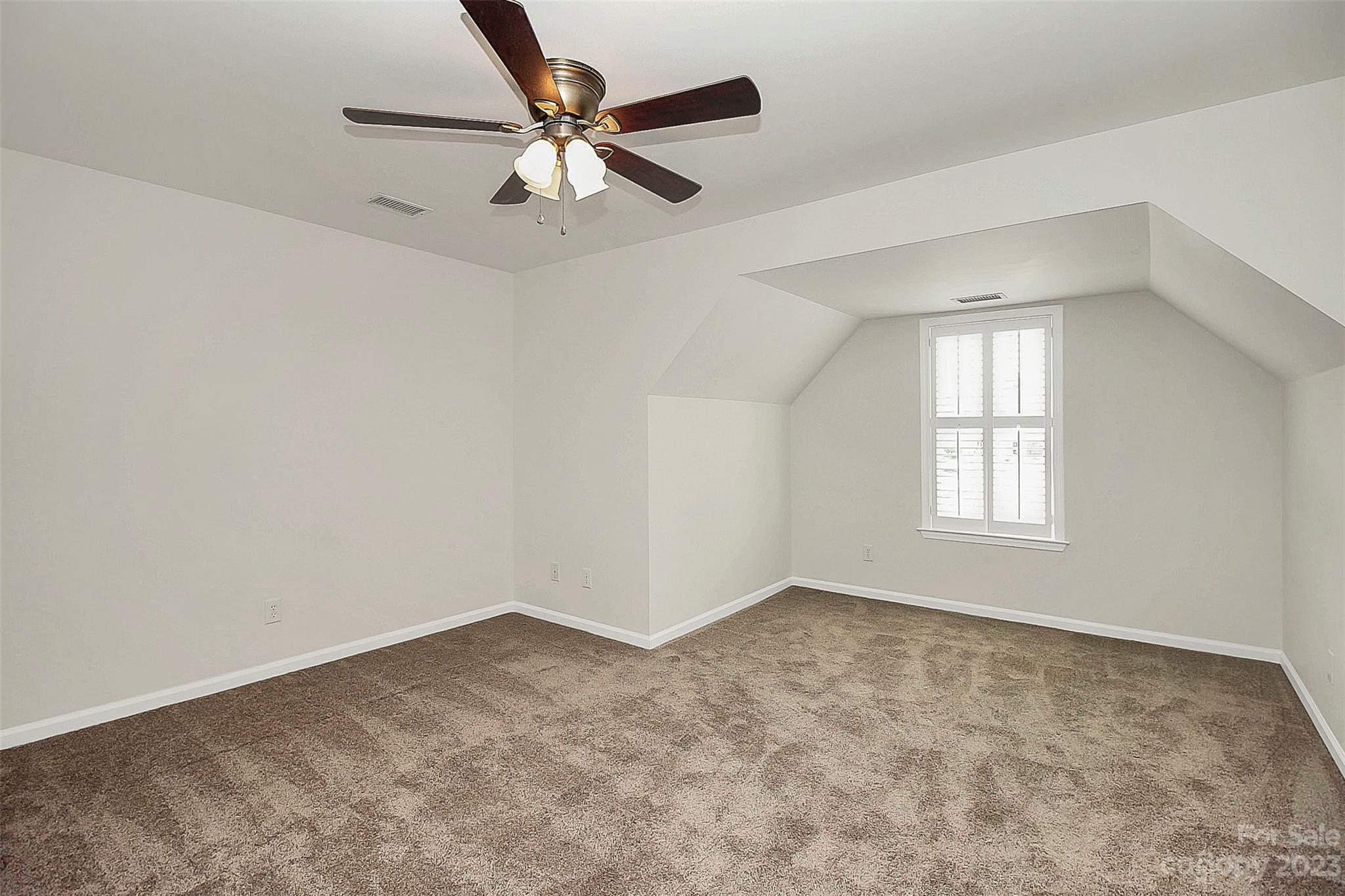 218 Robinlynn Road Matthews, NC 28105 - Photo 14 of 24 an empty room with a window and a fan