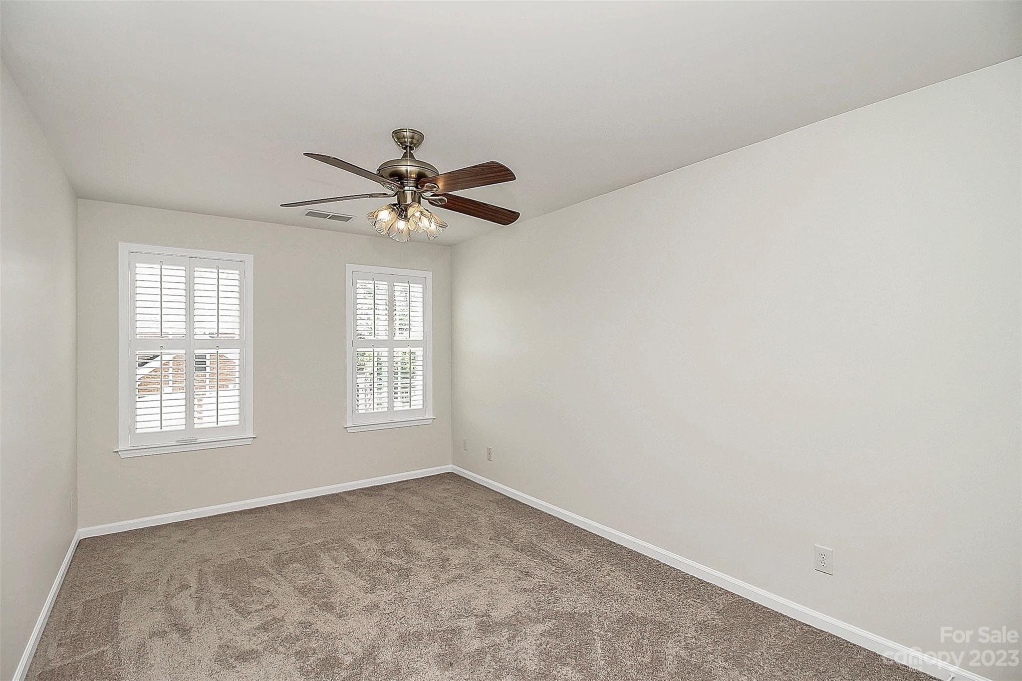218 Robinlynn Road Matthews, NC 28105 - Photo 15 of 24 an empty room with windows and fan