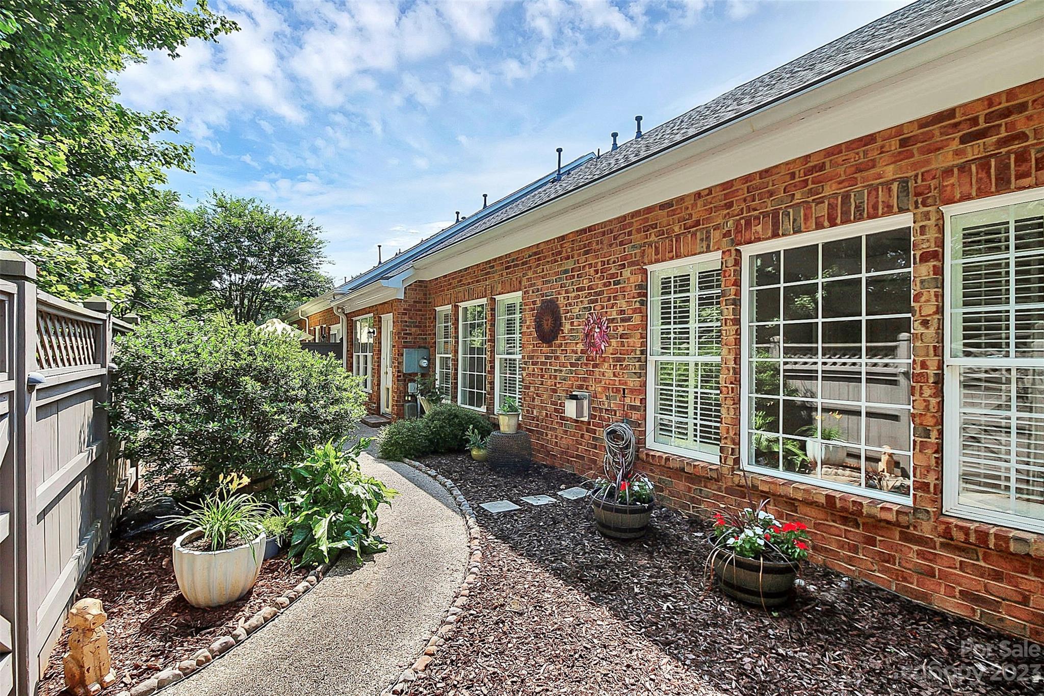 218 Robinlynn Road Matthews, NC 28105 - Photo 22 of 24 a front view of a house with a garden