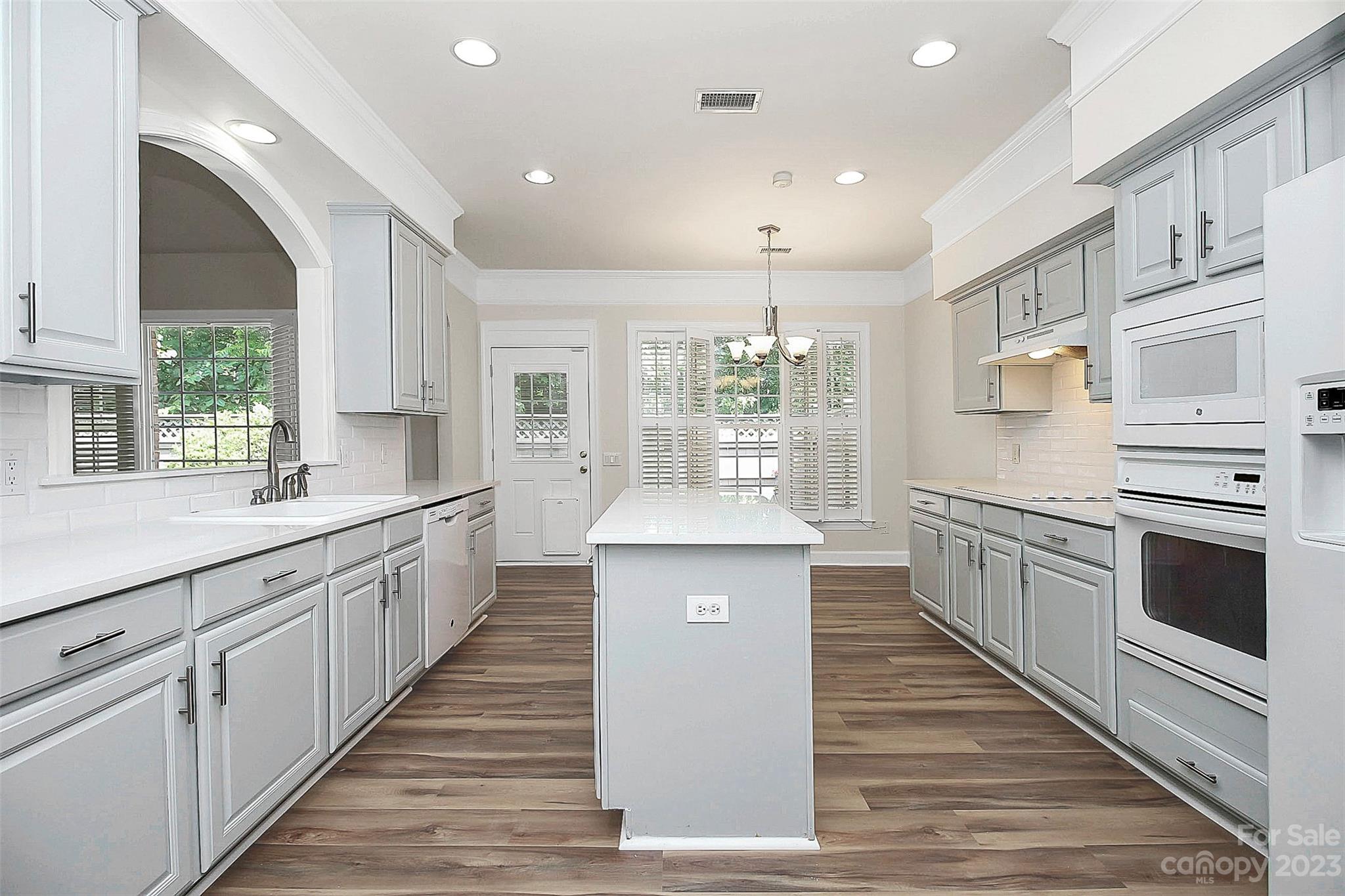 218 Robinlynn Road Matthews, NC 28105 - Photo 4 of 24 a large kitchen with stainless steel appliances lots of counter space and wooden floor