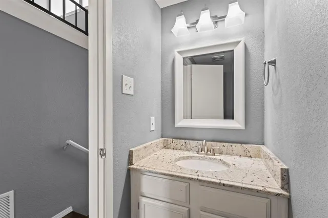 an empty room with closet and a chandelier fan