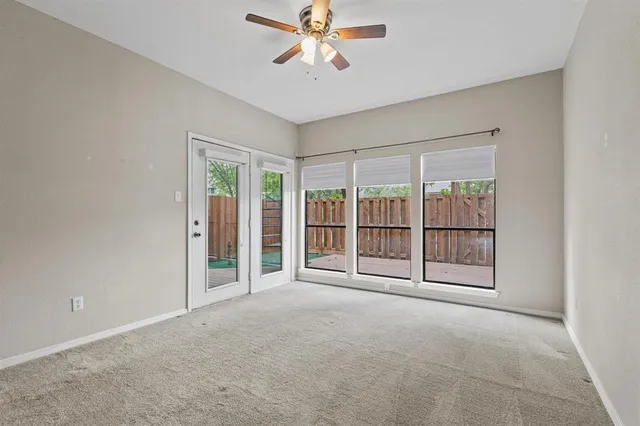 a view of an empty room with a ceiling fan
