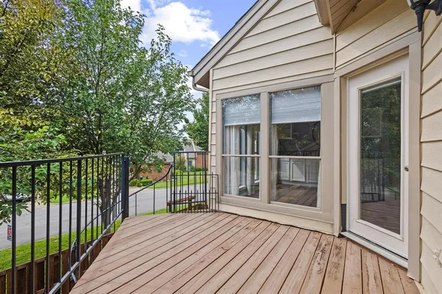 a view of a backyard with wooden fence and large trees