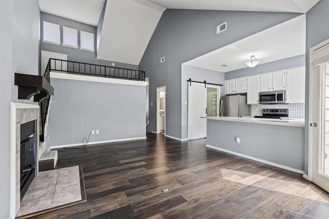 a kitchen with stainless steel appliances a refrigerator and a stove top oven