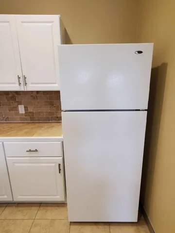 a white refrigerator freezer sitting in a kitchen