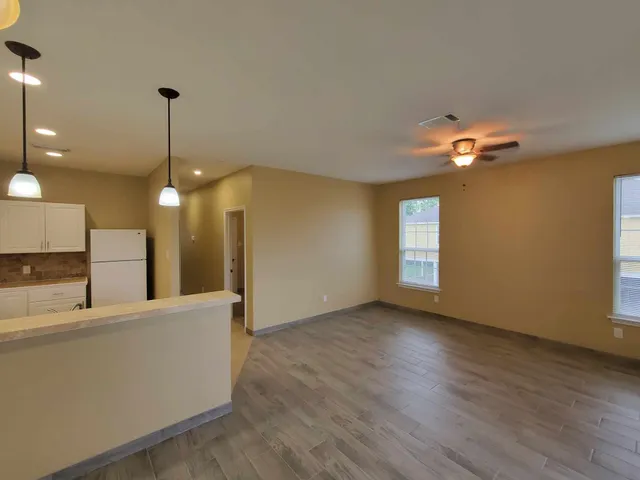 a view of a kitchen with a sink and a chandelier