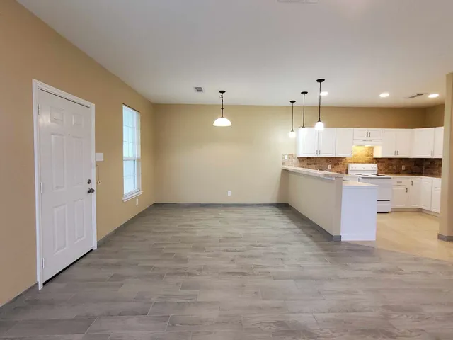 a large kitchen with a lot of counter space and appliances