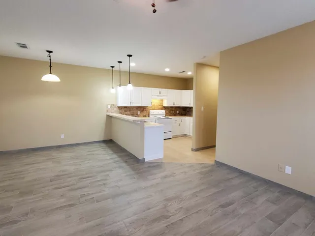 a large kitchen with a sink and a stove top oven
