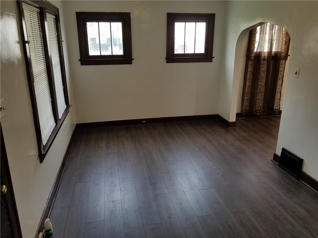 312 Trimble Street Carnegie, PA 15106 - Photo 2 of 15 an empty room with wooden floor and windows
