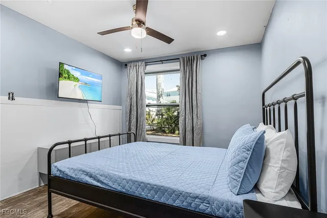 a bedroom with a bed and a painting on the wall