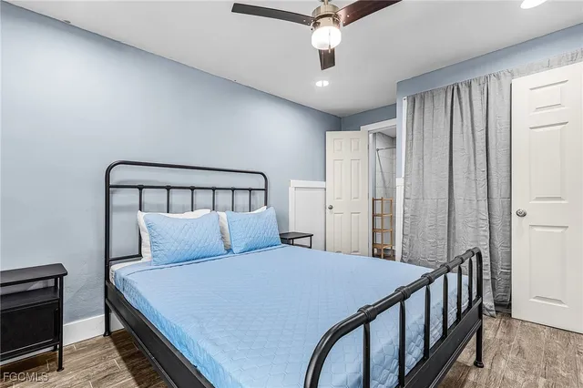 a bedroom with a large bed and a chandelier