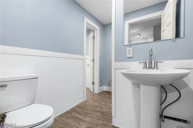 a bathroom with a sink toilet and mirror