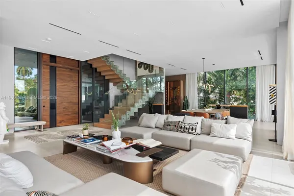 a living room with furniture and large windows