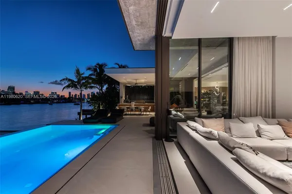 a living room with furniture and a floor to ceiling window