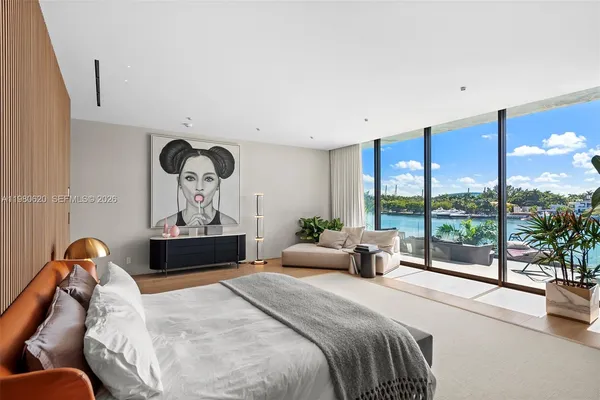 a view of a lake from a balcony with seating space