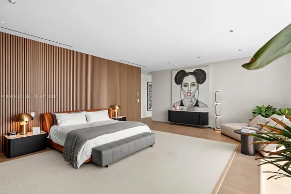 a living room with furniture a bookshelf and a large window