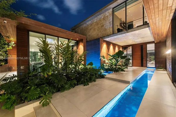 a backyard of a house with table and chairs