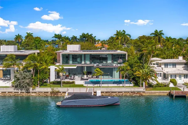 a front view of a building with swimming pool and outdoor seating