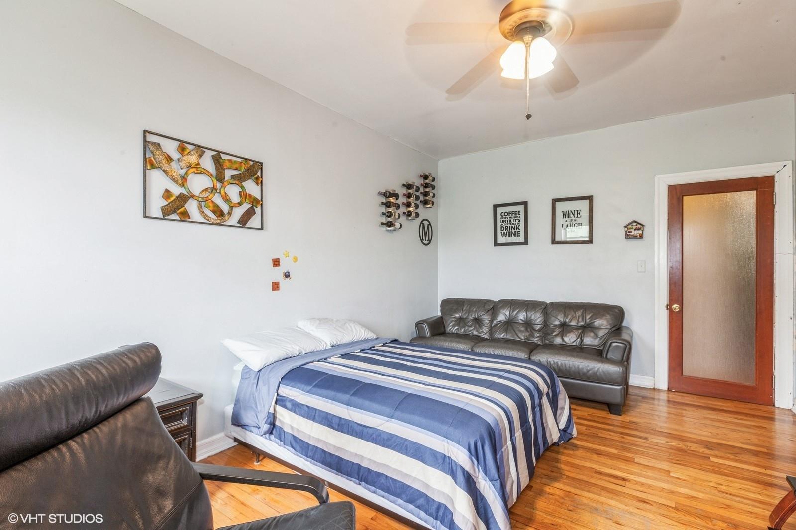 1670 Longfellow Avenue, Unit 6J Bronx, NY 10460 - Photo 4 of 15 a bedroom with a bed and a chandelier