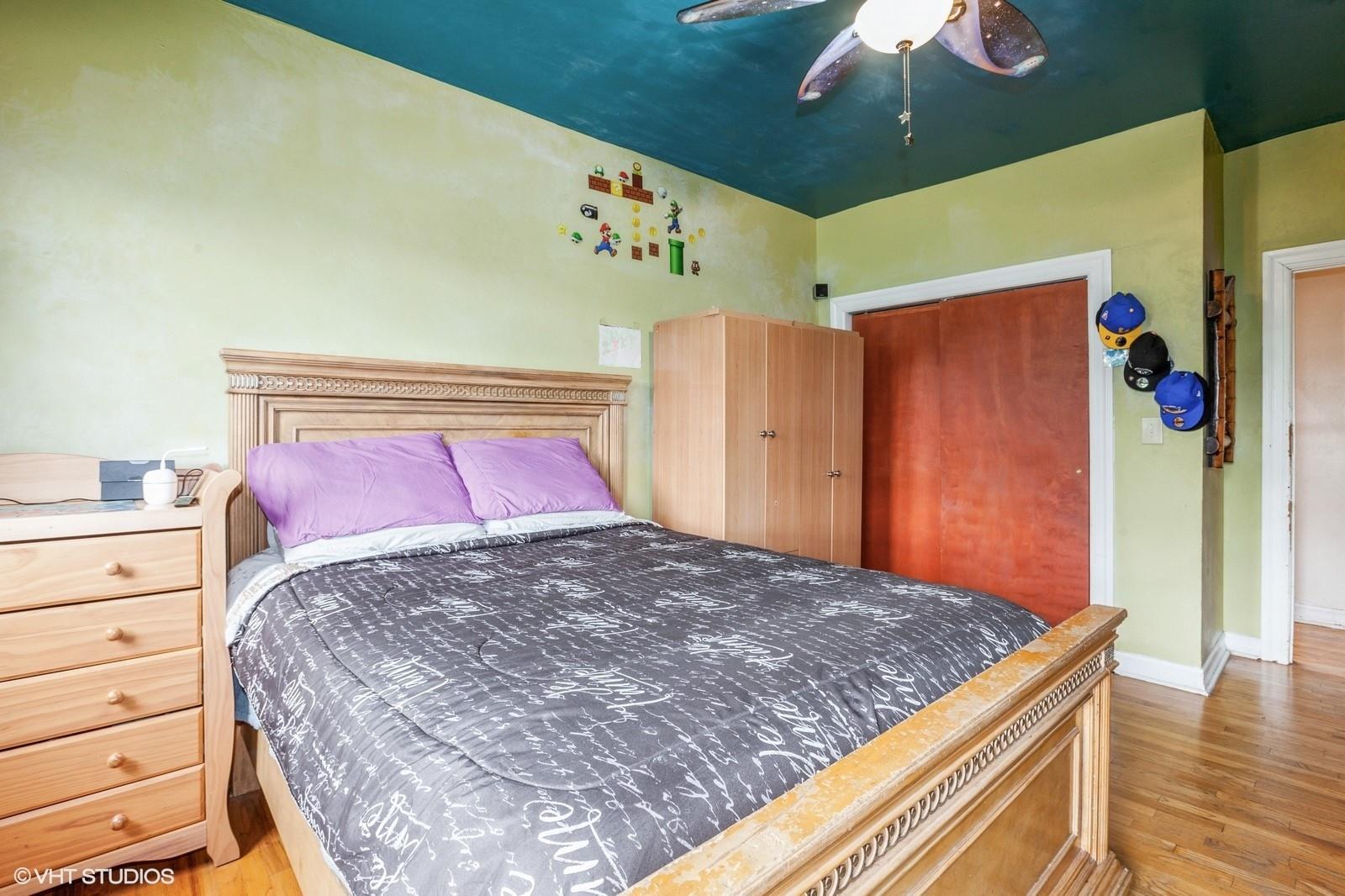 1670 Longfellow Avenue, Unit 6J Bronx, NY 10460 - Photo 5 of 15 a bedroom with a large bed and a chandelier