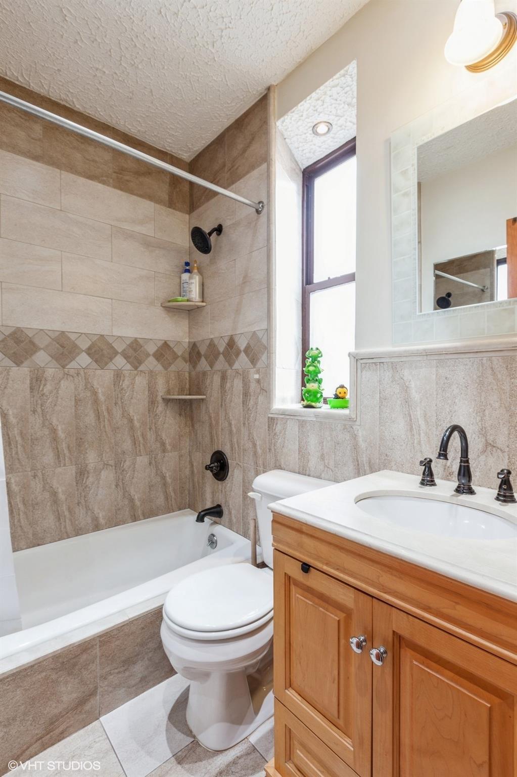 1670 Longfellow Avenue, Unit 6J Bronx, NY 10460 - Photo 9 of 15 a bathroom with a sink a toilet and a bathtub