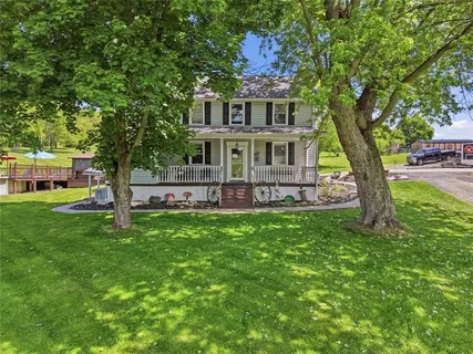a front view of a house with garden