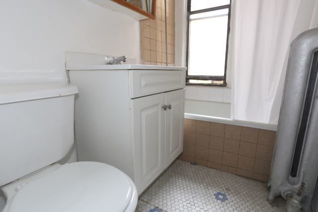 4604 North Beacon Street, Unit 3E Chicago, IL 60640 - Photo 13 of 13 a bathroom with a sink toilet and window