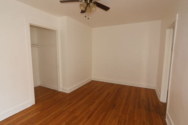 4604 North Beacon Street, Unit 3E Chicago, IL 60640 - Photo 8 of 13 an empty room with wooden floor cabinet and closet