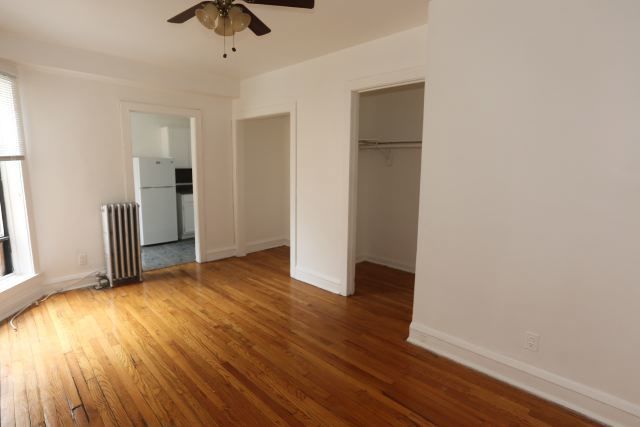 4604 North Beacon Street, Unit 3E Chicago, IL 60640 - Photo 9 of 13 wooden floor in an empty room with a window