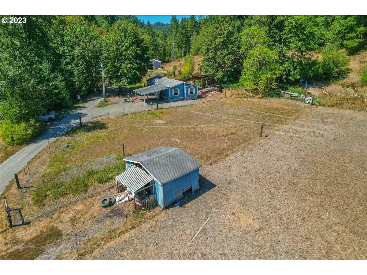 69802 Marcott Road Rainier, OR 97048 - Photo 3 of 10 a view of a backyard with lawn chairs under an umbrella