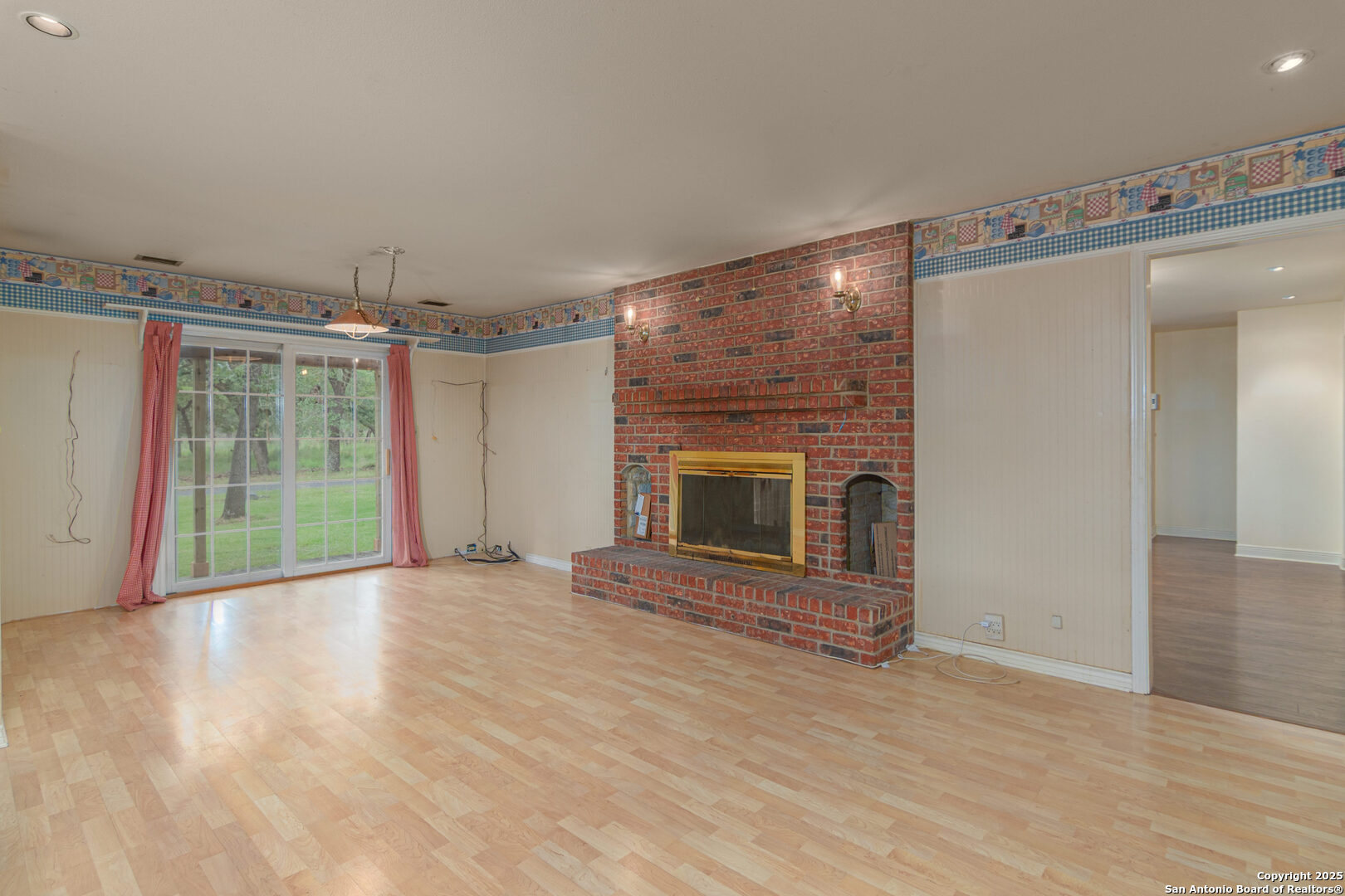 2981 Vivroux Ranch Road Seguin, TX 78155 - Photo 30 of 50 an empty room with wooden floor fireplace and windows