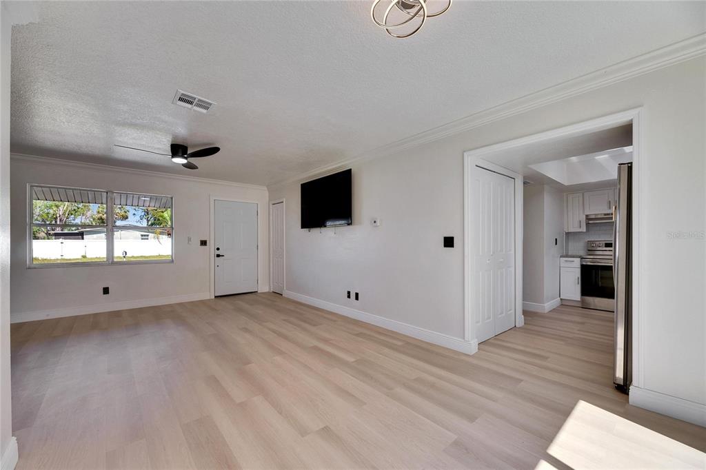 564 Florida Circle South Apollo Beach, FL 33572 - Photo 11 of 46 a view of an empty room with window and wooden floor