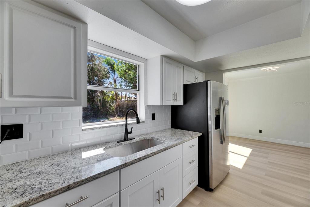 564 Florida Circle South Apollo Beach, FL 33572 - Photo 20 of 46 a kitchen with stainless steel appliances granite countertop a refrigerator and a sink
