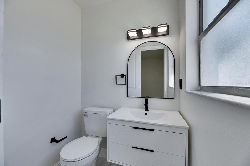 564 Florida Circle South Apollo Beach, FL 33572 - Photo 42 of 46 a bathroom with a toilet sink and mirror